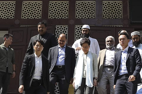 Hong Kong Chief Executive Carrie Lam, center, leaves a mosque in Hong Kong. (Photo | AP)