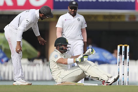 South Africa's Dean Elgar, center, reacts in pain after being hit on a delivery by India's Umesh Yadav. (Photo | AP)