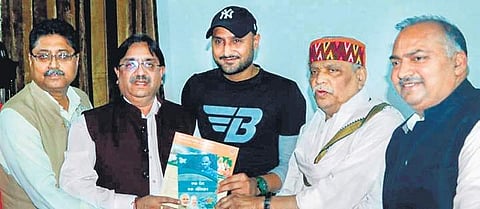 Punjab’s BJP in-charge Prabhat Jha with cricketer Harbhajan Singh during a public relations campaign for his party in Jalandhar on Sunday | PTI