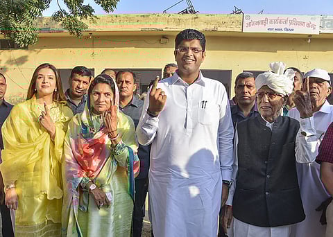 Dushyant Chautala, his wife Meghna Chautala and others show their fingers marked with indelible ink after casting  their votes. (Photo | PTI)