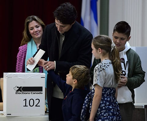 Canadian Prime Minister Justin Trudeau, second from left, votes with wife Sophie Gregoire-Trudeau, and children Xavier, Ella-Grace and Hadrien in Montreal. (Photo | AP)