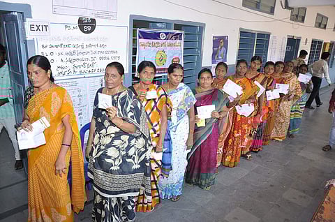 Voters in queue line to cast their votes at various polling booths of Huzurnagar on Monday| Express