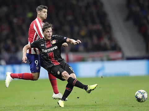 Leverkusen's Julian Baumgartlinger kicks the ball ahead of Atletico Madrid's Alvaro Morata (Photo | AP)