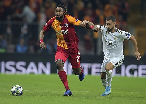 Galatasaray's Christian Luyindama, left, duels for the ball with Real Madrid's Eden Hazard. (Photo | AP)