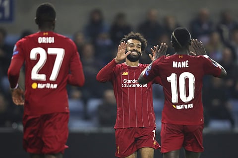 Liverpool's Mohamed Salah, center, is congratulated by Liverpool's Sadio Mane. (Photo | AP)