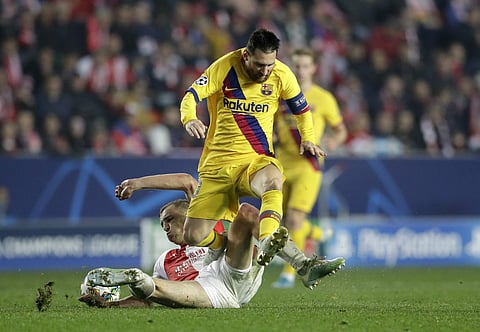 Barcelona's Lionel Messi, top, duels for the ball with Slavia's Tomas Soucek. (Photo | AP)