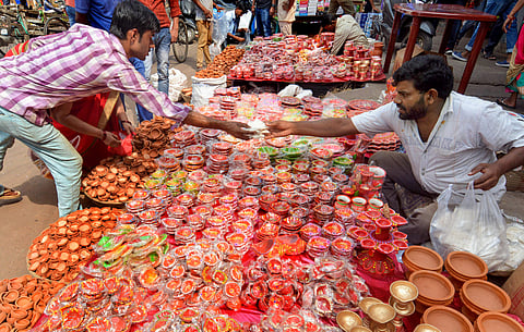 Vendors sell colourful earthen lamps along a roadside for the upcoming Diwali festival, at Fancy Bazar in Guwahati. (Photo | PTI)