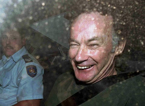 Serial killer Ivan Milat smiles in a police car after attending a court in Sydney, Australia. (Photo | AP)