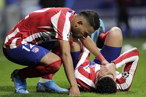 Atletico Madrid's Renan Lodi, left, comforts Atletico Madrid's Mario Hermoso. (Photo | AP)