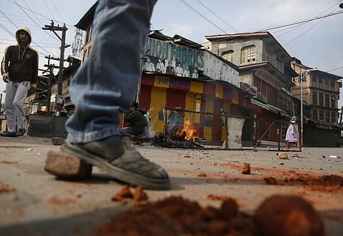Kashmiri youth protesting against India throw bricks and make fire to block traffic on a road in Srinagar, Indian controlled Kashmir, Sunday, Oct. 27, 2019.