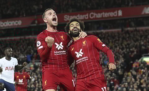 Liverpool's Mohamed Salah, right, celebrates with his teammate Jordan Henderson after scoring his side's second goal. (Photo | AP)