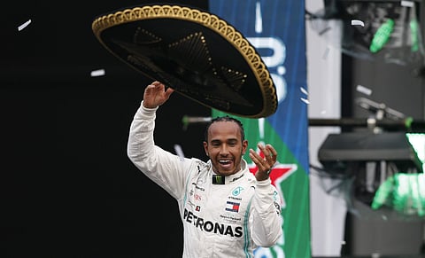 Mercedes driver Lewis Hamilton, of Britain, throws a Mexican Charro hat to the crowd. (Photo | AP)