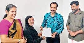 Amina handing over the written assurance to Kavilumpara grama panchayat secretary Rejulal M P that her granddaughter’s wedding would be conducted as per green protocol