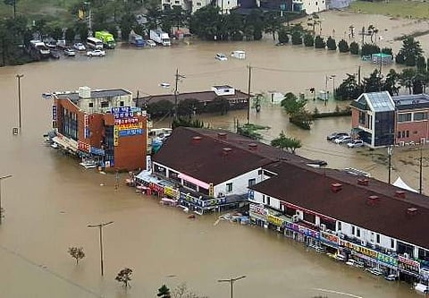 Buildings are inundated by floodwaters from heavy rains caused by Typhoon Mitag. (Photo |AFP)