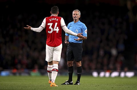 Arsenal's Granit Xhaka speaks to referee Martin Atkinson. (Photo | AP)