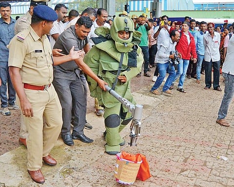 A file photo of a bomb squad personnel taking out a package suspected to contain explosives at the Hubballi Railway Station | Express