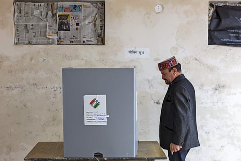 A voter walks to a polling enclosure to cast his ballot (Photo | AP)