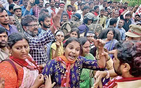 Police officials restrain TSRTC employees who tried to stop buses at the venue of the public meeting in Hyderabad on Wednesday | Vinay Madapu
