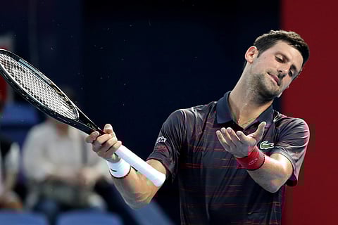 Novak Djokovic of Serbia reacts after he missed a shot against Go Soeda of Japan during a second round of Japan Open Tennis Championships in Tokyo. (Photo | AP)