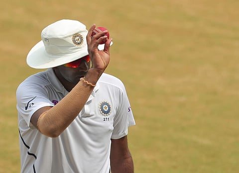 Indian cricketer Ravichandran Ashwin holds the ball up while leaving the ground. (Photo | AP)