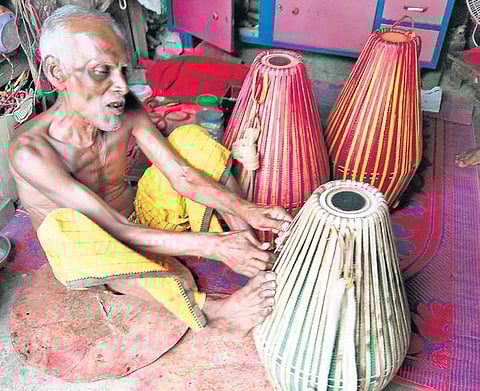 Bimal Das busy making traditional musical instruments at Madhiala village