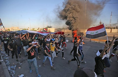 Iraqi protesters take part in a demonstration against state corruption, failing public services, and unemployment, in the Iraqi capital Baghdad. (Photo|AFP)