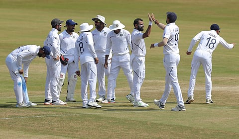 Indian bowler Mohammed Shami, with out cap, celebrates with team members after dismissing South Africa's Temba Bavuma. (Photo | AP)