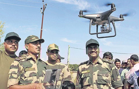BSF officials explain the working of drone to the border area villagers at Gole Pattan village in Kanachak sector of Indo-Pak border, about 25 km from Jammu on Saturday. (Photo | PTI)