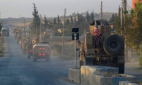 US military vehicles travel down a main road in northeast Syria. (Photo| AP)