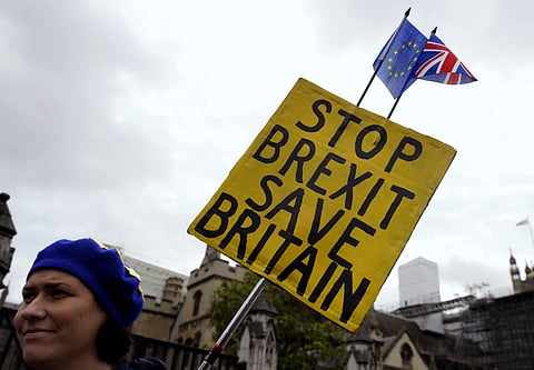 An anti-Brexit campaigner holds a banner near Parliament in London. (Photo| AP)