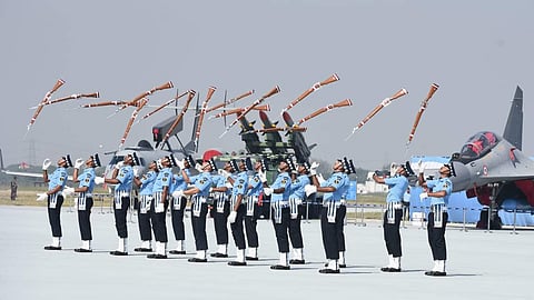 IAF personnel display their skills with rifles during Indian Air Force Day celebrations. 