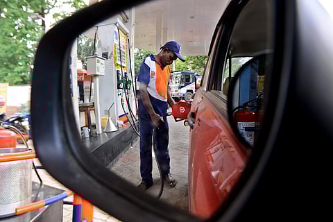 An employee at a petrol bunk fills fuel in a car. (Photo | Debadatta Mallick, EPS)