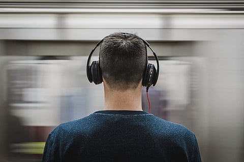 Image of a man listening to music on his headphones used for representational purposes only.