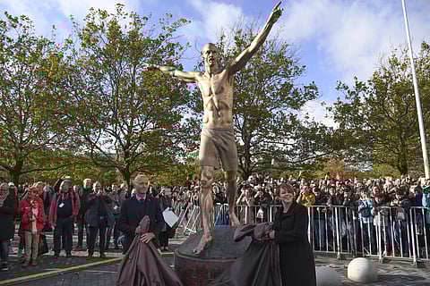 Swedish Soccer Federation General Secretary Hakan Sjostrand, left, and Chairman of Malmo municipal executive board Katrin Stjernfeldt Jammeh unveil of a 2.7m bronze statue of Swedish soccer star Zlatan Ibrahimovic near Malmo Stadium in Malmo. (Photo | AP)