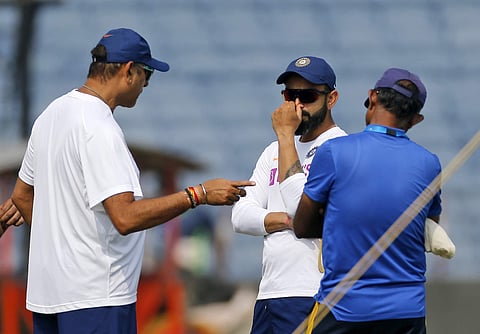 Indian cricket team captain Virat Kohli listens to coach Ravi Shastri during a practice session ahead of the second test match between India and South Africa in Pune. (Photo | AP)