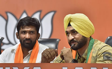 Former Indian hockey captain Sandeep Singh and Olympic medallist wrestler Yogeshwar Dutt talk to the media after joining BJP in New Delhi. (File| PTI)
