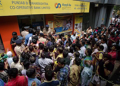 Account holders line up in front of a branch of PMC Bank (Photo| Bloomberg)