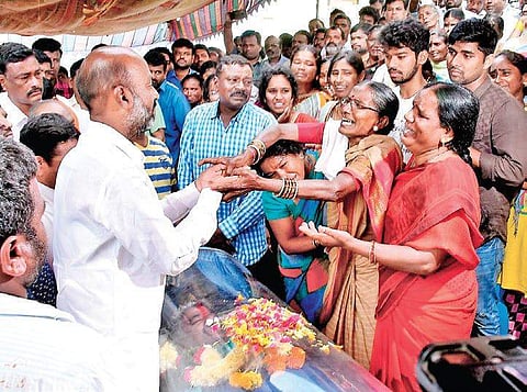 BJP MP Bandi Sanjay Kumar consoling the family of deceased driver N Babu during a sit-in protest at their residence in Arepall of Karimnagar on Thursday