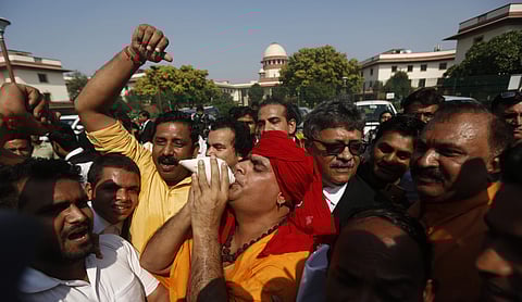 Swami Chakrapani Maharaj celebrates after the verdict of Ayodhya Babri Masjid Land case at the lawn of the Supreme Court of India in New Delhi on Saturday. | (Photo | Arun Kumar P/EPS)