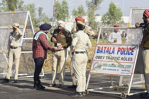 A Sikh pilgrim shows his documents to police before crossing over to Pakistan for the inauguration ceremony of the Kartarpur Corridor. (File Photo | AFP)
