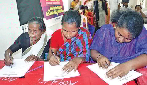 80-year-old Paru, her daughter Ragini P and granddaughter Rajani R writing the Aksharasree literacy exam of Kerala State Literacy Mission at the community hall in Puthenpalam, Kannammoola in Thiruvananthapuram | Express