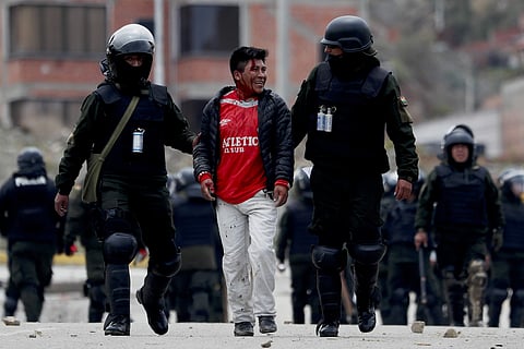 Police detain a supporter of former President Evo Morales during clashes on the south side of La Paz, Bolivia. (Photo | AP)