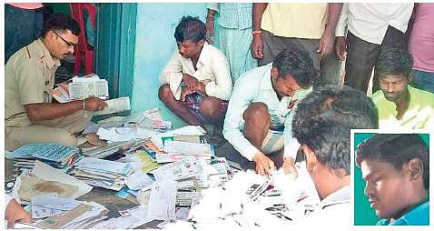 Villagers sort out letters and parcels that were found during the raid at the post office-cum-residence of Suresh Chawadi in Sanganal village of Koppal district