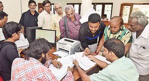 People standing in queue to submit applications at SIT office at Yeleru Guest House in the city on Monday|  Express