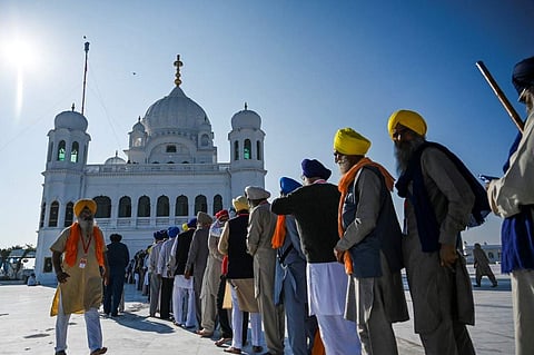 Sikh pilgrims stand in a queue to visit the Shrine of Baba Guru Nanak Dev at Gurdwara Darbar Sahib in Kartarpur. (Photo | AFP)