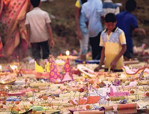 Devotees float miniature boats made of plantain,