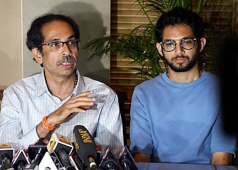 Shiv Sena chief Uddhav Thackeray addresses a press conference as his son and Yuva Sena chief Aaditya Thackeray looks on in Mumbai Tuesday, Nov. 12 2019. | (Photo | PTI)