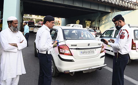 Traffic policemen impose penalty on a traffic offender for riding a vehicle with a number plate ending with an ODD digit during the Odd-Even scheme, in New Delhi on November 6, 2019. (Photo | Parveen Negi, EPS)