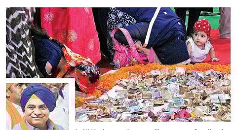A child looks on as devotees offer prayers to Guru Nanak during the Vishal Deewan; MAUD minister KT Rama Rao sporting a turban for the event, at Exhibition Grounds in Nampally on Tuesday | S Senbagapandiyan
