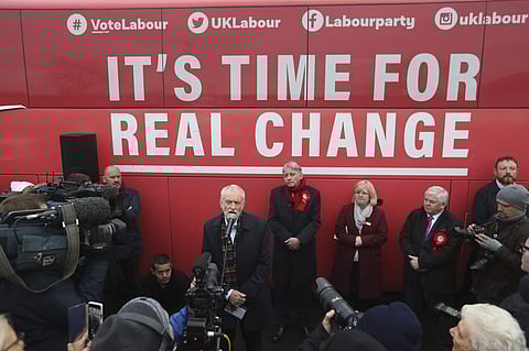 Britain's main opposition Labour Party leader Jeremy Corbyn, speaks to the media and supporters in front of the Labour campaign bus during General Election campaign, during a visit to Birkenshaw Sports Barn in Uddingston, south Lanarkshire, Scotland, Wedn